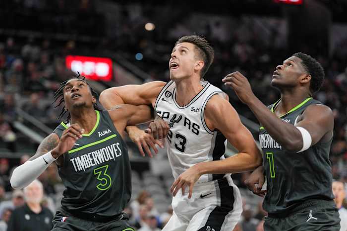 San Antonio Spurs forward Zach Collins (23) battles for position with Minnesota Timberwolves forwards Jaden McDaniels (3) and Anthony Edwards (1) at the AT&T Center in San Antonio on Oct. 30, 2022.
